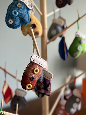 Close up of tree with mitten ornaments